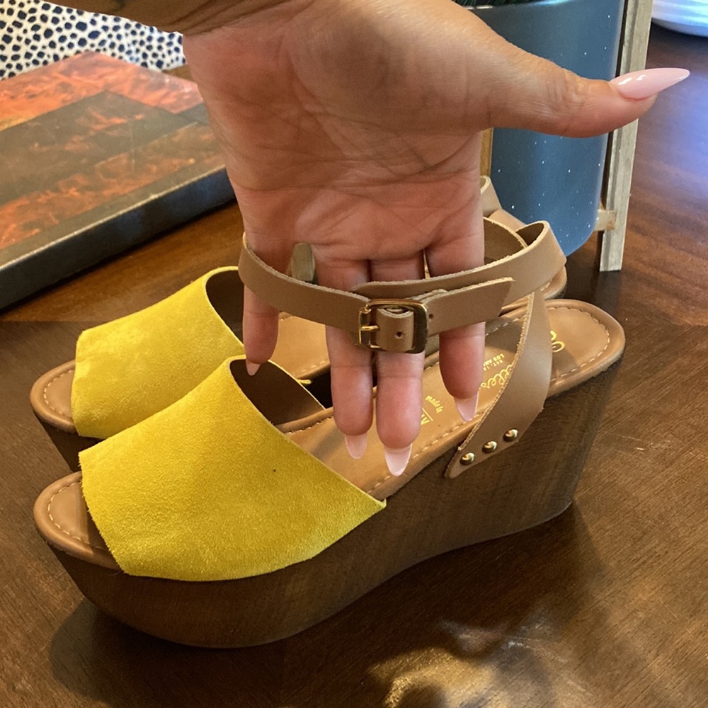 Size 9 yellow wedge heel with brown bottom.